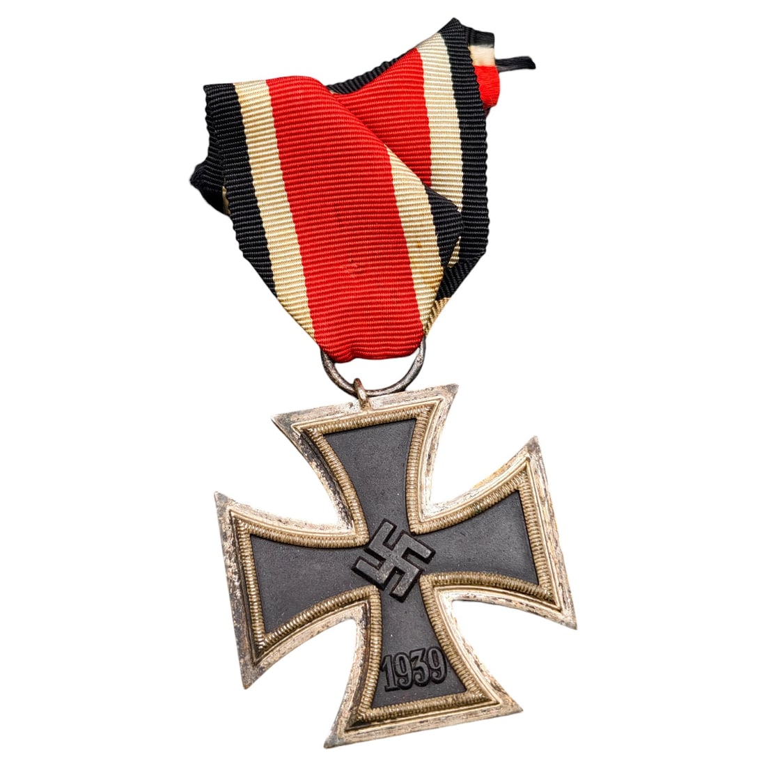 1939 Iron Cross 2nd Class: A World War II German Iron Cross Second Class (Eisernes Kreuz 2. Klasse), dated 1939, obverse featuring a mobile swastika at center and dated 1813 to reverse.