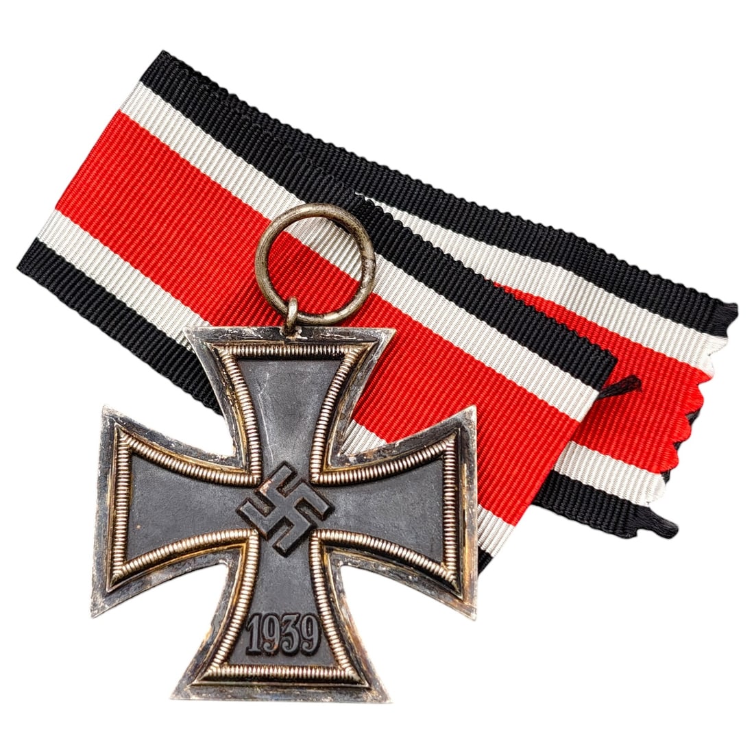 1939 Iron Cross 2nd Class: A World War II German Iron Cross Second Class (Eisernes Kreuz 2. Klasse), dated 1939, obverse featuring a mobile swastika at center and dated 1813 to reverse.