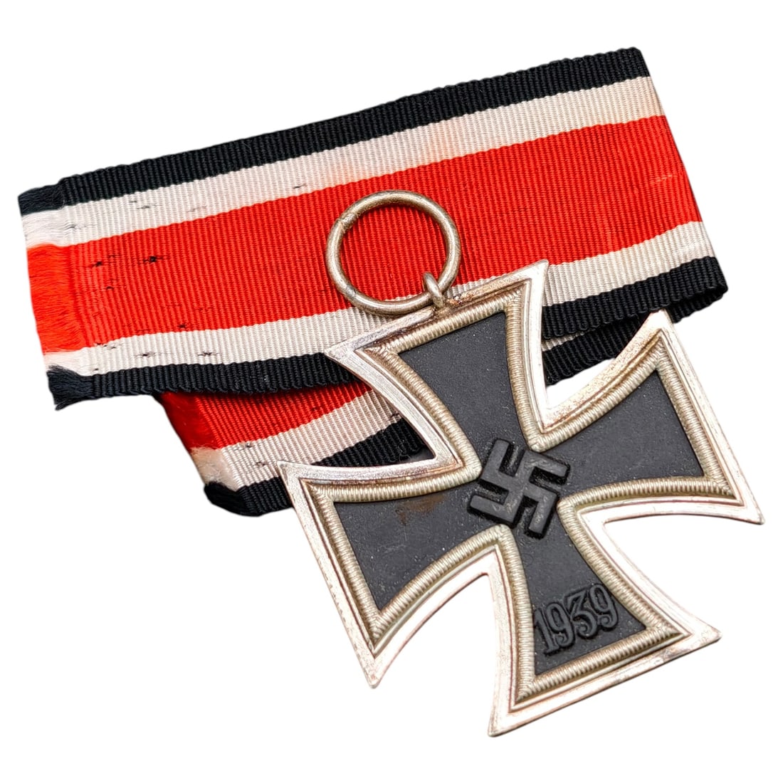 1939 Iron Cross 2nd Class: A World War II German Iron Cross Second Class (Eisernes Kreuz 2. Klasse), dated 1939, obverse featuring a mobile swastika at center and dated 1813 to reverse.
