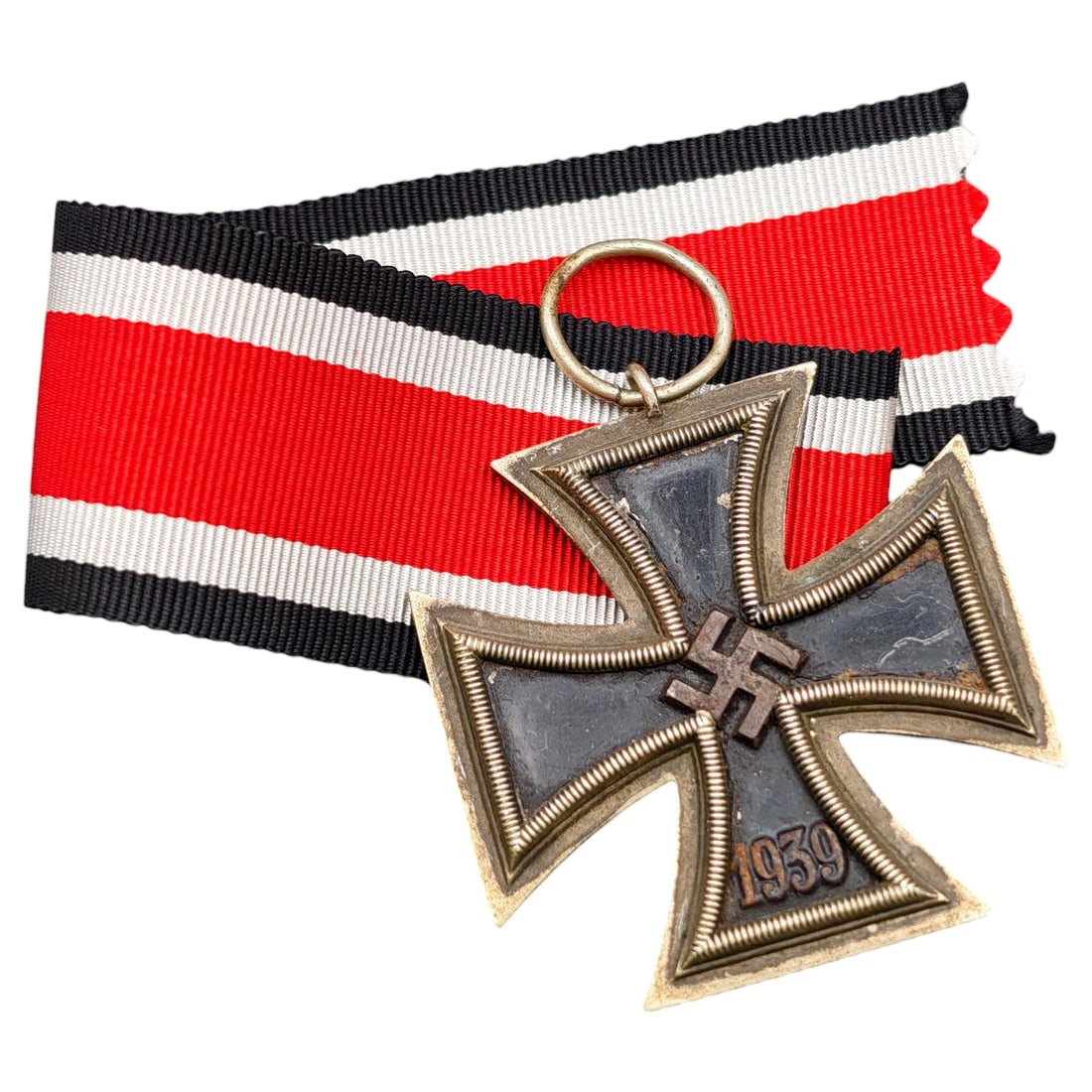 1939 Iron Cross 2nd Class: A World War II German Iron Cross Second Class (Eisernes Kreuz 2. Klasse), dated 1939, obverse featuring a mobile swastika at center and dated 1813 to reverse.