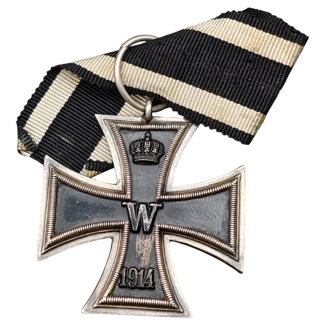 1914 Iron Cross 2nd Class: A WWI-era Iron Cross 2nd Class, dated 1914, with crowned 'W' cypher on the obverse and reverse showing 'FW' cypher, oak leaves, and '1813' commemorating the original 1813 founding of the order.The Iro