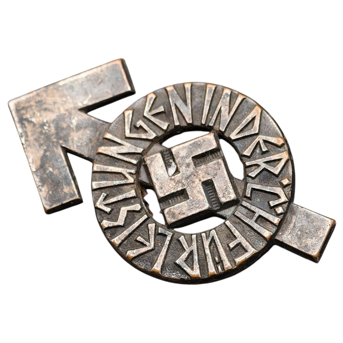 Hitler Youth Proficiency Badge: A cast metal proficiency/achievement badge for the Hitler Youth, inscribed 'LEISTUNGEN IN DER R.G.... FÜHRER' with central swastika within a circular wreath-like ring, mounted on a stylized Sig-rune 