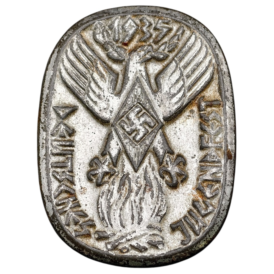 Hitler Youth Jugendfest 1935 Badge: A stamped badge in what appears to be white-metal commemorating a 1935 Hitler Youth festival ('Jugendfest'), featuring a stylized eagle with outstretched wings above a diamond-shaped shield bearing a 