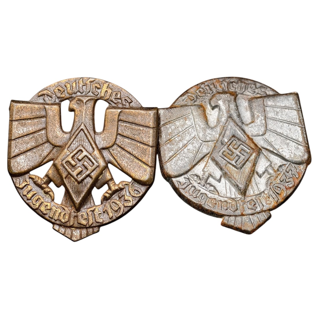 Hitler Youth HJ Jugendfest 1936 & 1937 Tinnie Badges (Pair): A set of pin-back tinnie badges commemorating the 'Deutsches Jugendfest' (German Youth Festival), dated 1936 and 1937 respectively. Each features a stylized eagle with outstretched wings over a swasti