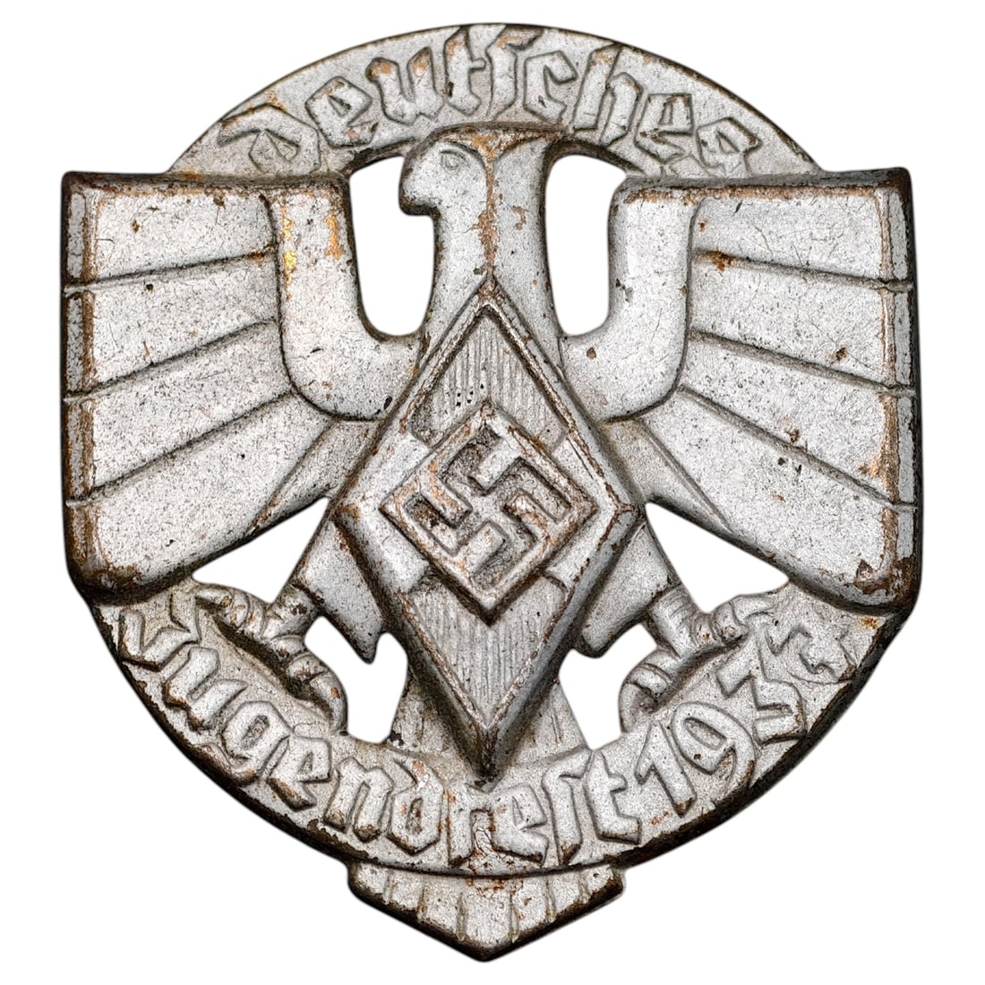 Third Reich Deutsches Jugendfest 1934 Tinnie Badge: A stamped metal tinnie/badge commemorating a German Youth Festival (Deutsches Jugendfest), featuring an eagle with outstretched wings above a Hitler Youth diamond emblem with swastika. The banner text