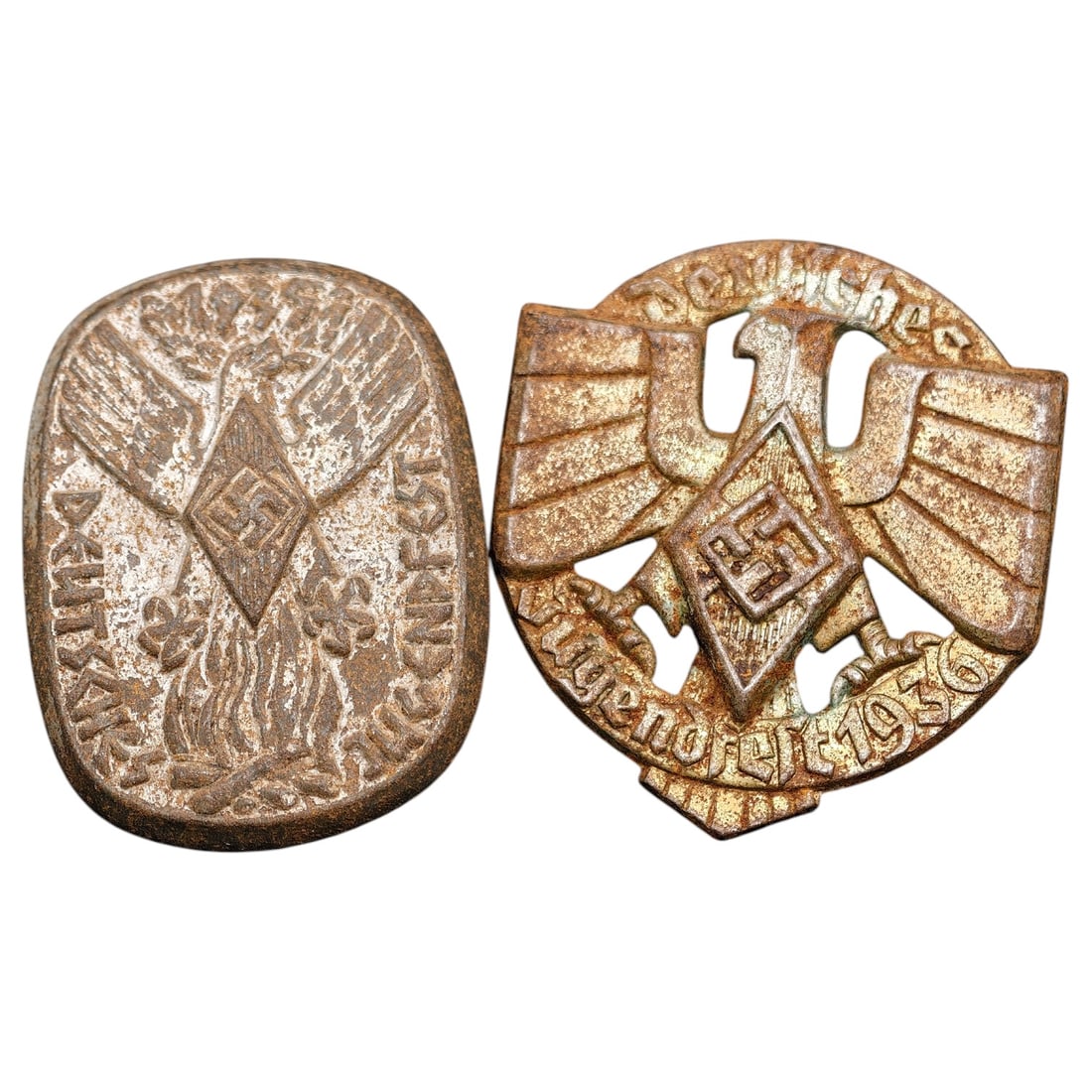 Third Reich German Youth Festival ('Deutsches Jugendfest') Badge Pair, One Dated 1936: A pair of pin-back membership/event badges, both featuring a stylized eagle with swastika motif. The rounded example is inscribed 'Deutsches Jugendfest' with foliate detailing, while the shield-form b