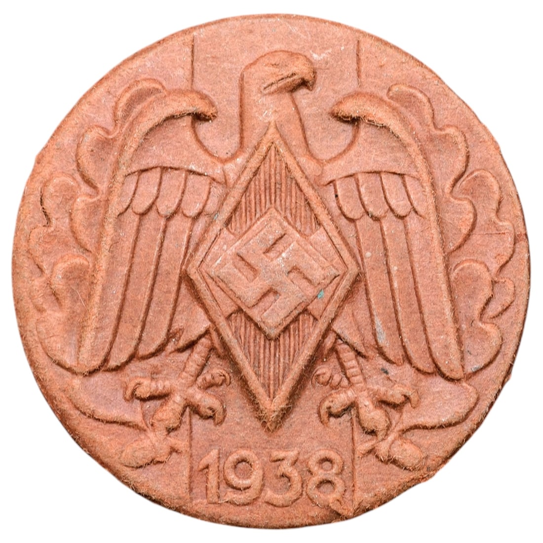 German WWII Nazi Hitler Youth 1938 Tinnie Badge: A pressed fiber/composition 'tinnie' badge featuring a stylized eagle with wings spread, clutching a diamond-shaped shield with swastika, dated 1938 at the base. Surface shows a reddish-brown pressed 