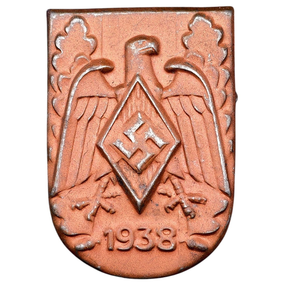 Third Reich 1938 HJ/NSDAP Rally Tinnie Badge: A pressed metal shield-shaped badge dated 1938, featuring a stylized eagle with wings spread above a Hitler Youth diamond emblem, flanked by oak leaves and crossed swords/daggers. Surface shows a copp