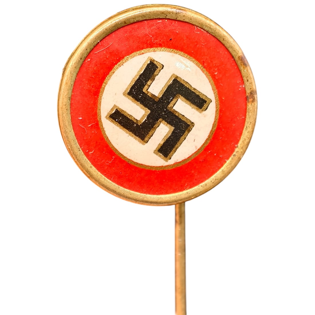 Early NSDAP Celluloid Pin: A round stick pin featuring a black swastika on a white field, surrounded by a red enamel border with a rim in what appears to be gilt-toned metal. No maker markings are visible in the photos.