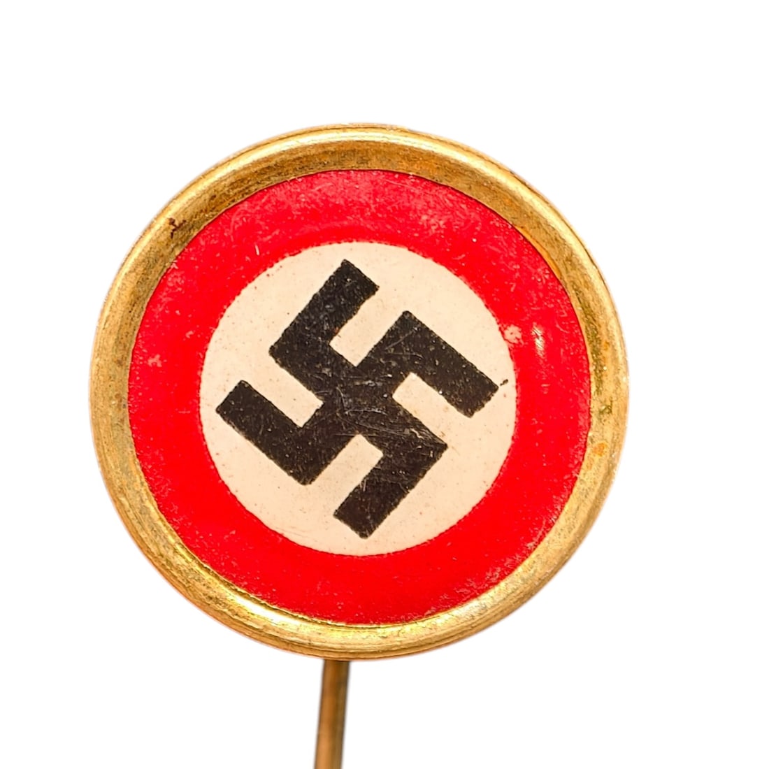Early NSDAP Celluloid Pin: A small round stick pin featuring a field in what appears to be red celluloid with white center disc and black swastika, set in a frame in what appears to be brass-toned metal.