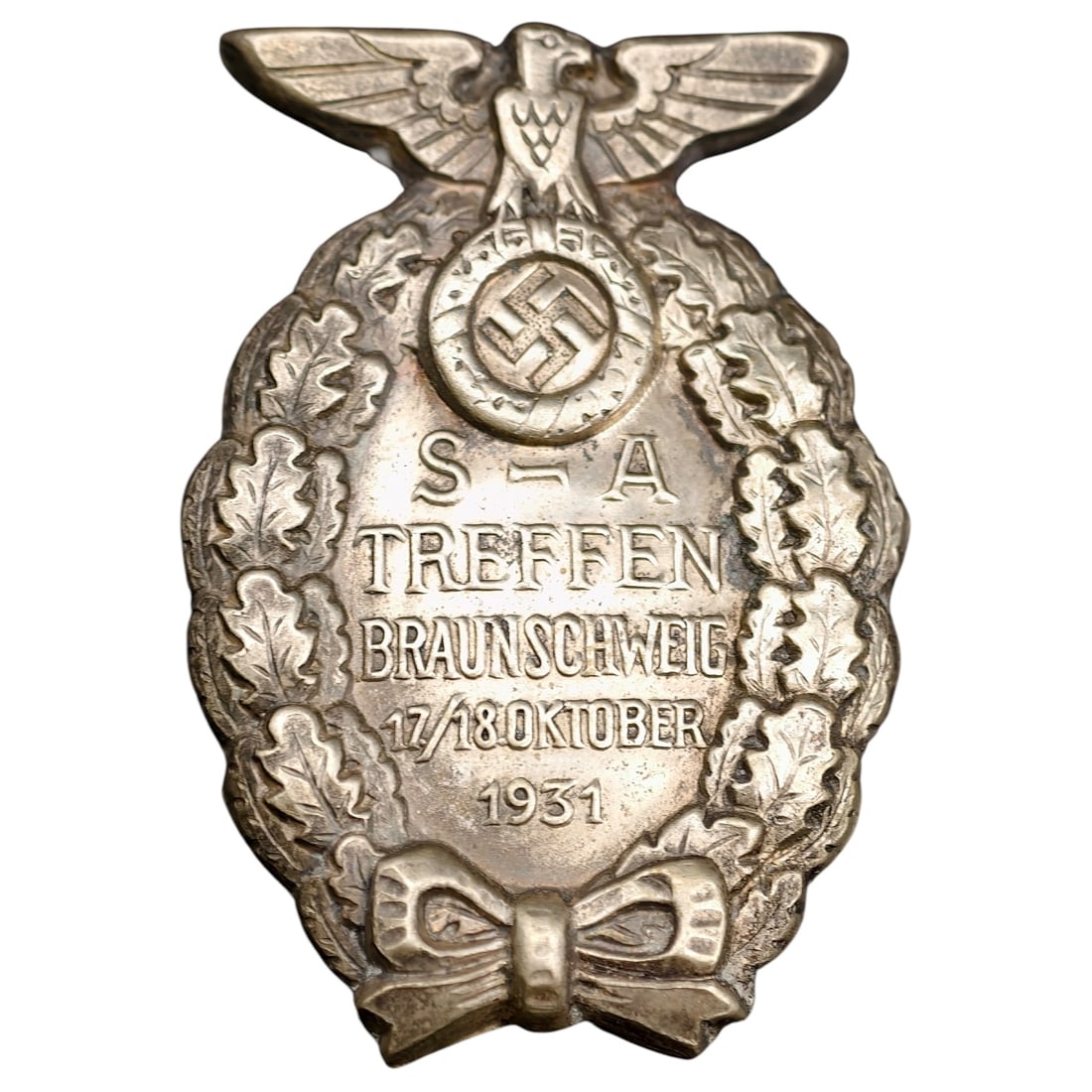 Early NSDAP SA Treffen Braunschweig 1931 Tinnie: Oval-form commemorative badge (tinnie) issued for the SA Treffen held in Braunschweig on 17/18 October 1931. Die-struck in a white metal alloy, the obverse depicts a stylized eagle above a wreathed