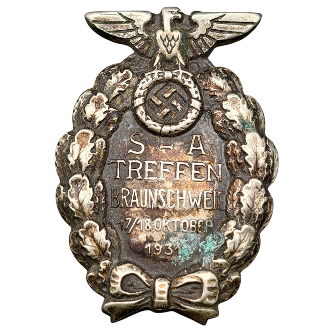 NSDAP SA Treffen Braunschweig 1931 Badge: A tinnie-style badge commemorating the SA Treffen (Sturmabteilung rally) held in Braunschweig on 17/18 October 1931. The badge features an eagle atop a wreath-encircled swastika medallion, with