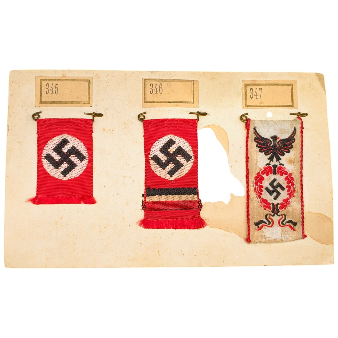 Early NSDAP Ribbon Set on Salesman Card: A set of small woven miniature pennants mounted on an old collector's/salesman's card, each numbered with an original paper tag (345, 346, 347). Some pennants are red woven bunting with a central whit