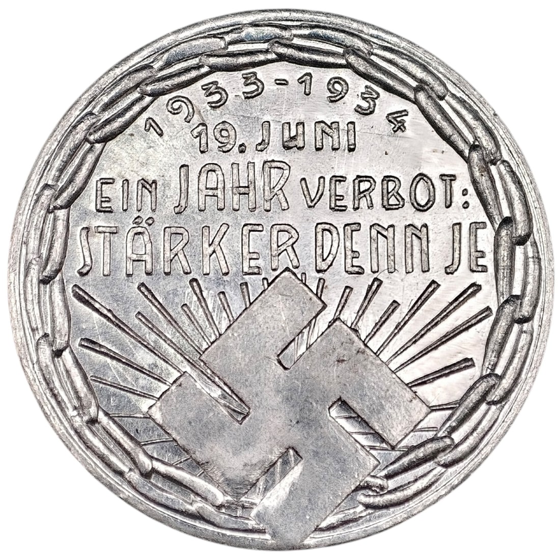 Third Reich Nazi Heil Hitler Token: Cast token in what appears to be white metal, a propaganda piece commemorating one year of the 1933 Austrian ban on the NSDAP. Obverse reads "1933-1934, 19. Juni, EIN JAHR VERBOT: STÄRKER DENN JE"