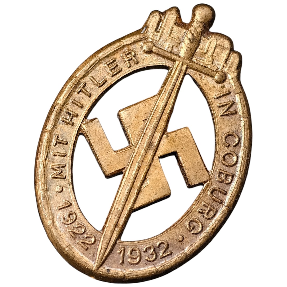 Third Reich Coburg Badge Miniature Stickpin: Miniature stickpin version of the Coburg Badge, commemorating the NSDAP march on Coburg, inscribed 'MIT HITLER IN COBURG 1922 1932' surrounding a swastika crossed by a sword and mailed fist. Cast in a