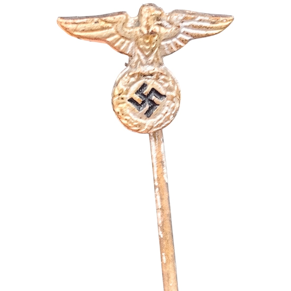 Third Reich Nazi NSDAP Eagle Stickpin: A small lapel stickpin featuring a stylized eagle with wings spread, perched atop a roundel bearing a swastika. The pin is fashioned in a finish that appears to be white-metal or silvered over base