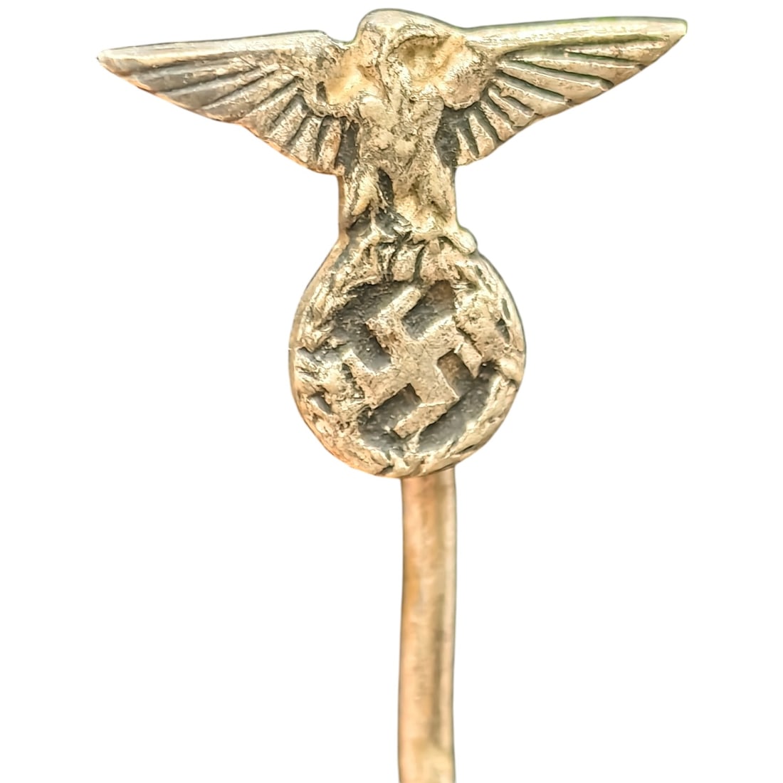 NSDAP Eagle Stickpin: A stickpin featuring a cast eagle with outstretched wings perched atop a wreathed swastika. The eagle and roundel are finished in what appears to be a gold-tone metal with detailed feather and wreath