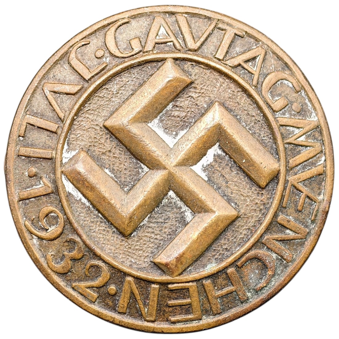 Early NSDAP 1932 Badge: A round tinnie-style badge commemorating the Gautag Munich event, dated 17.1.1932. The obverse displays a raised swastika within a beaded circular border, surrounded by the inscription "GAUTAG
