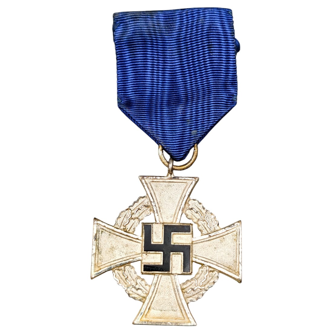 25 Year Faithful Service Medal - Third Reich Nazi Era Medal: A cross-form long-service award in metal that appears to be silvered, featuring an oak leaf wreath surrounding a central black-enameled swastika on the obverse, with the reverse inscribed "Für treue 