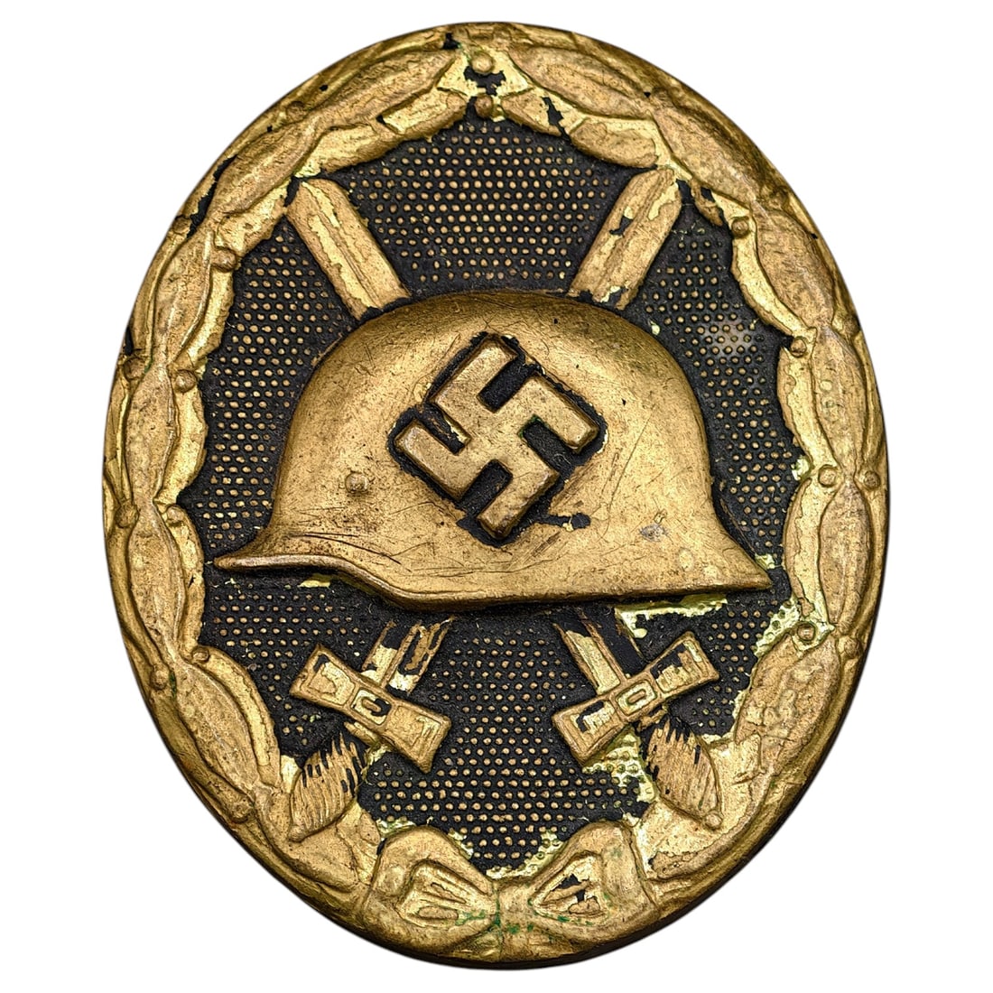 Wound Badge in Black – Third Reich Nazi Era Medal Badge: A Third Reich Wound Badge (Verwundetenabzeichen) in what appears to be black grade, depicting a steel helmet over a swastika, flanked by crossed swords, within a wreath border.