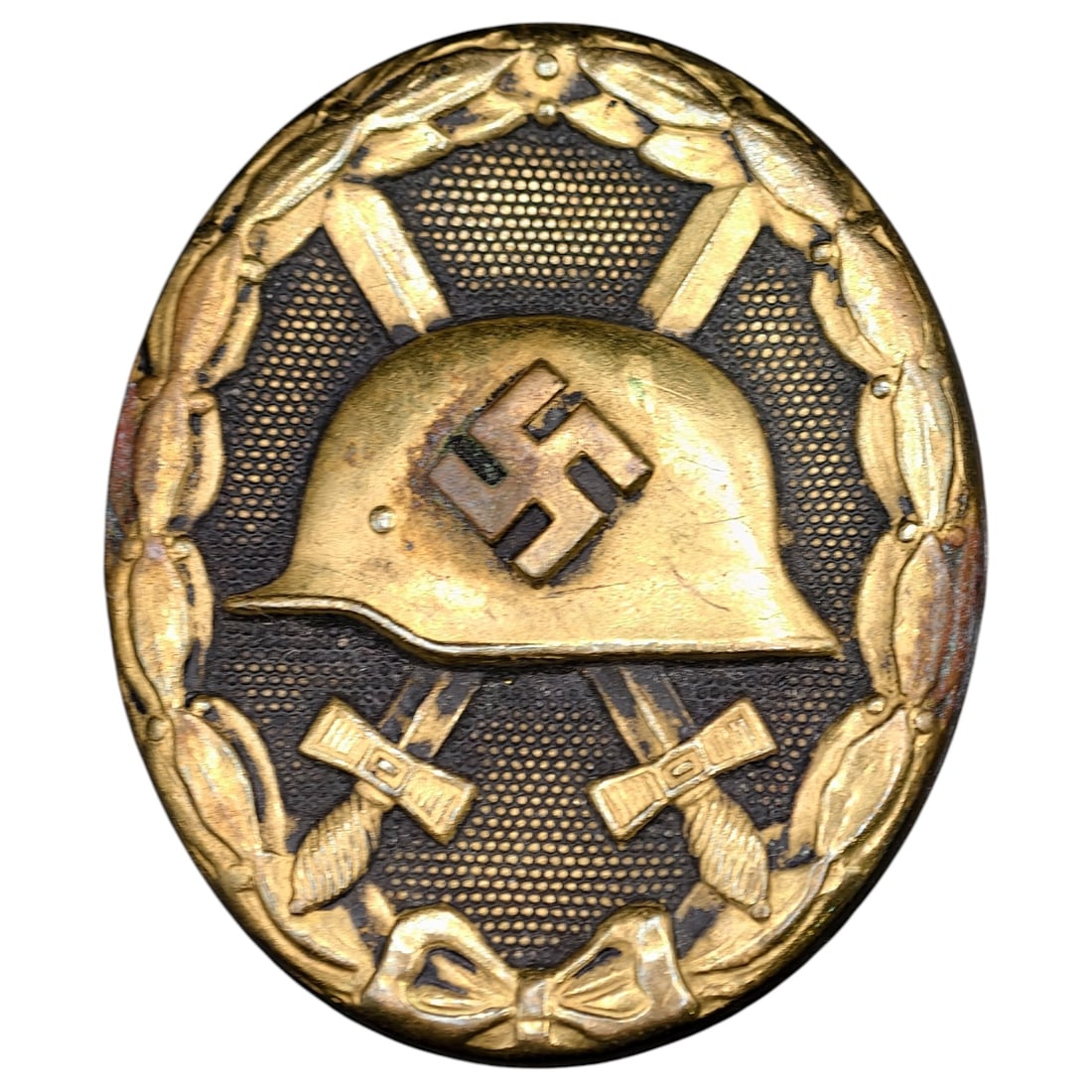 Wound Badge in Black – Third Reich Nazi Era Medal Badge: A Third Reich Wound Badge (Verwundetenabzeichen) in what appears to be black grade, depicting a steel helmet over a swastika, flanked by crossed swords, within a wreath border.