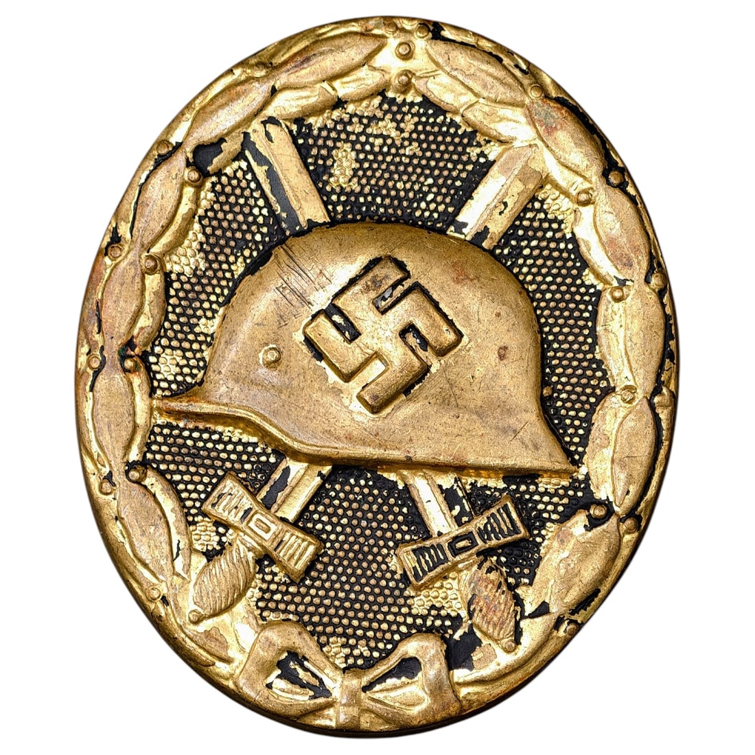 Wound Badge in Black – Third Reich Nazi Era Medal Badge: A Third Reich Wound Badge (Verwundetenabzeichen) in what appears to be black grade, depicting a steel helmet over a swastika, flanked by crossed swords, within a wreath border.