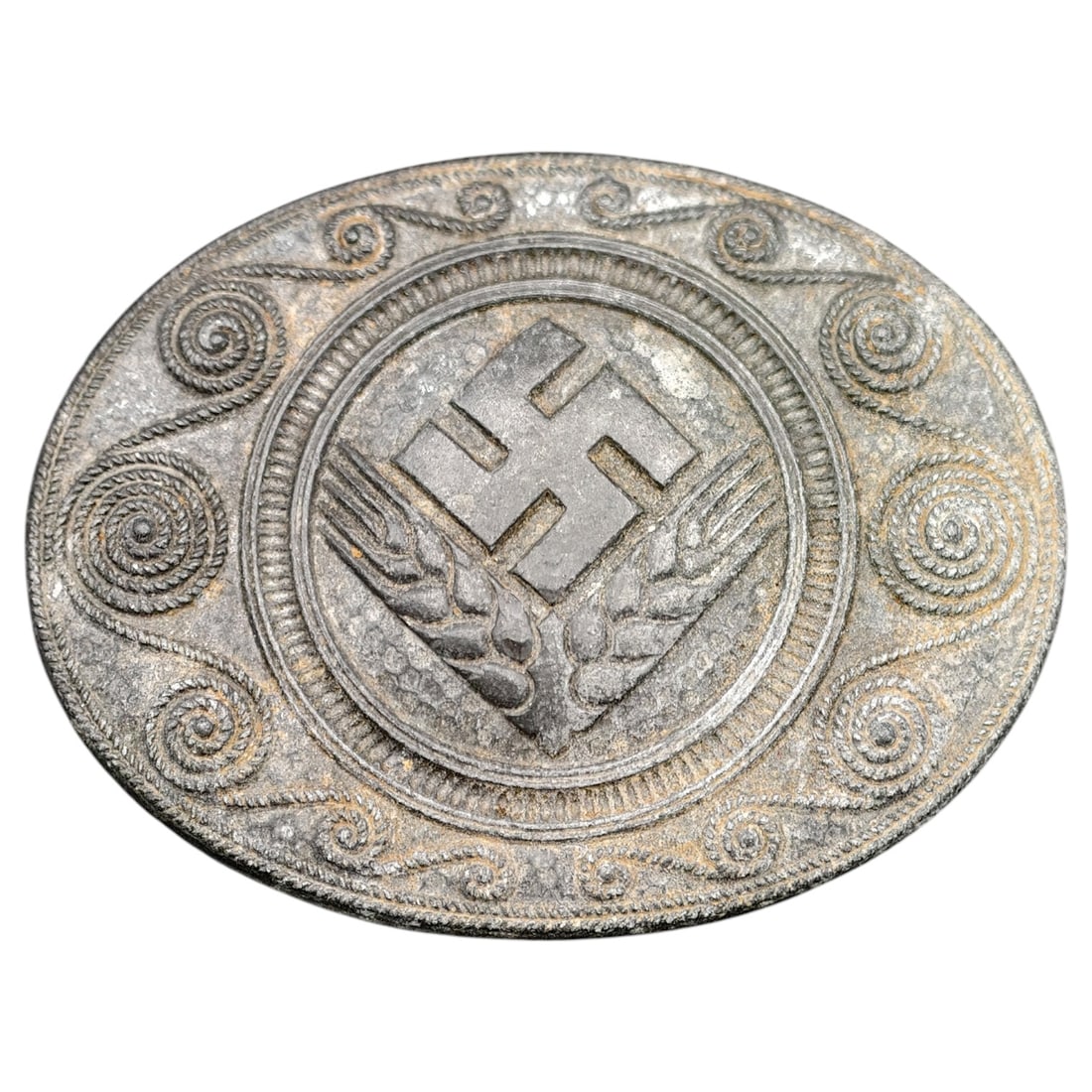 Third Reich Nazi RADwJ Brooch: Oval pin-back brooch featuring a swastika over crossed wheat sheaves, surrounded by a rope-and-scroll decorative border, likely associated with the Reichsarbeitsdienst der weiblichen Jugend (RADwJ).