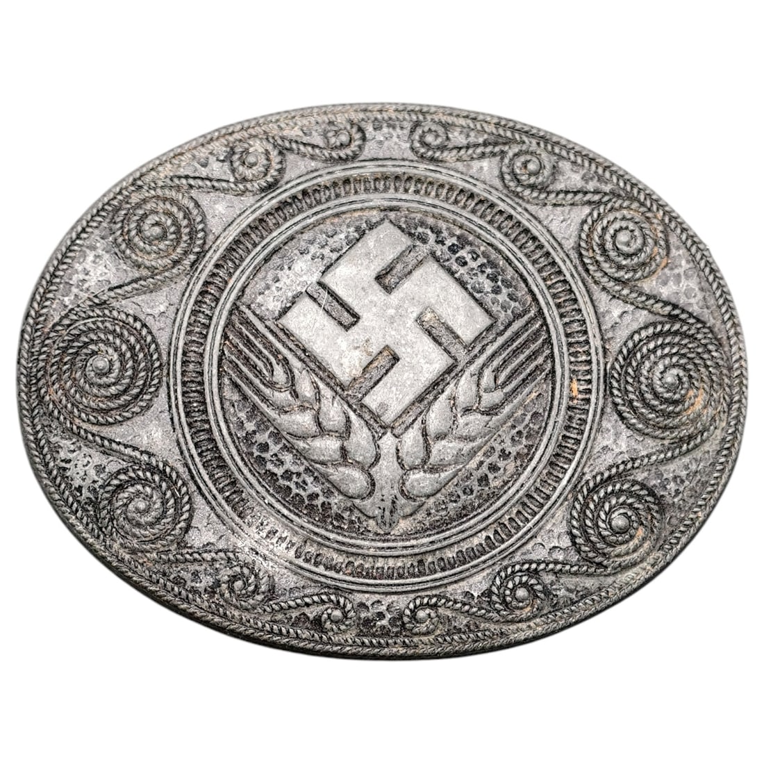 Third Reich Nazi RADwJ Brooch: Oval pin-back brooch featuring a swastika over crossed wheat sheaves, surrounded by a rope-and-scroll decorative border, likely associated with the Reichsarbeitsdienst der weiblichen Jugend (RADwJ).