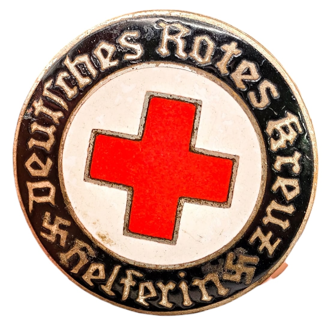 Third Reich Nazi Red Cross Badge: Enameled member badge for the Deutsches Rotes Kreuz (German Red Cross), inscribed "DEUTSCHES ROTES KREUZ HELFERIN" around a central red cross on white enamel field with black outer ring and gothic let