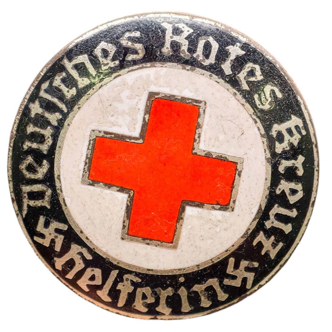 Third Reich Nazi Red Cross Badge: Enameled member badge for the Deutsches Rotes Kreuz (German Red Cross), inscribed "DEUTSCHES ROTES KREUZ HELFERIN" around a central red cross on white enamel field with black outer ring and gothic let