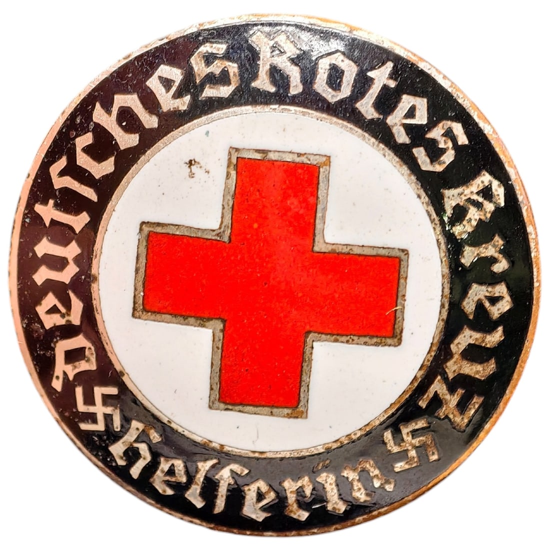 Third Reich Nazi Red Cross Badge: Enameled member badge for the Deutsches Rotes Kreuz (German Red Cross), inscribed "DEUTSCHES ROTES KREUZ HELFERIN" around a central red cross on white enamel field with black outer ring and gothic let