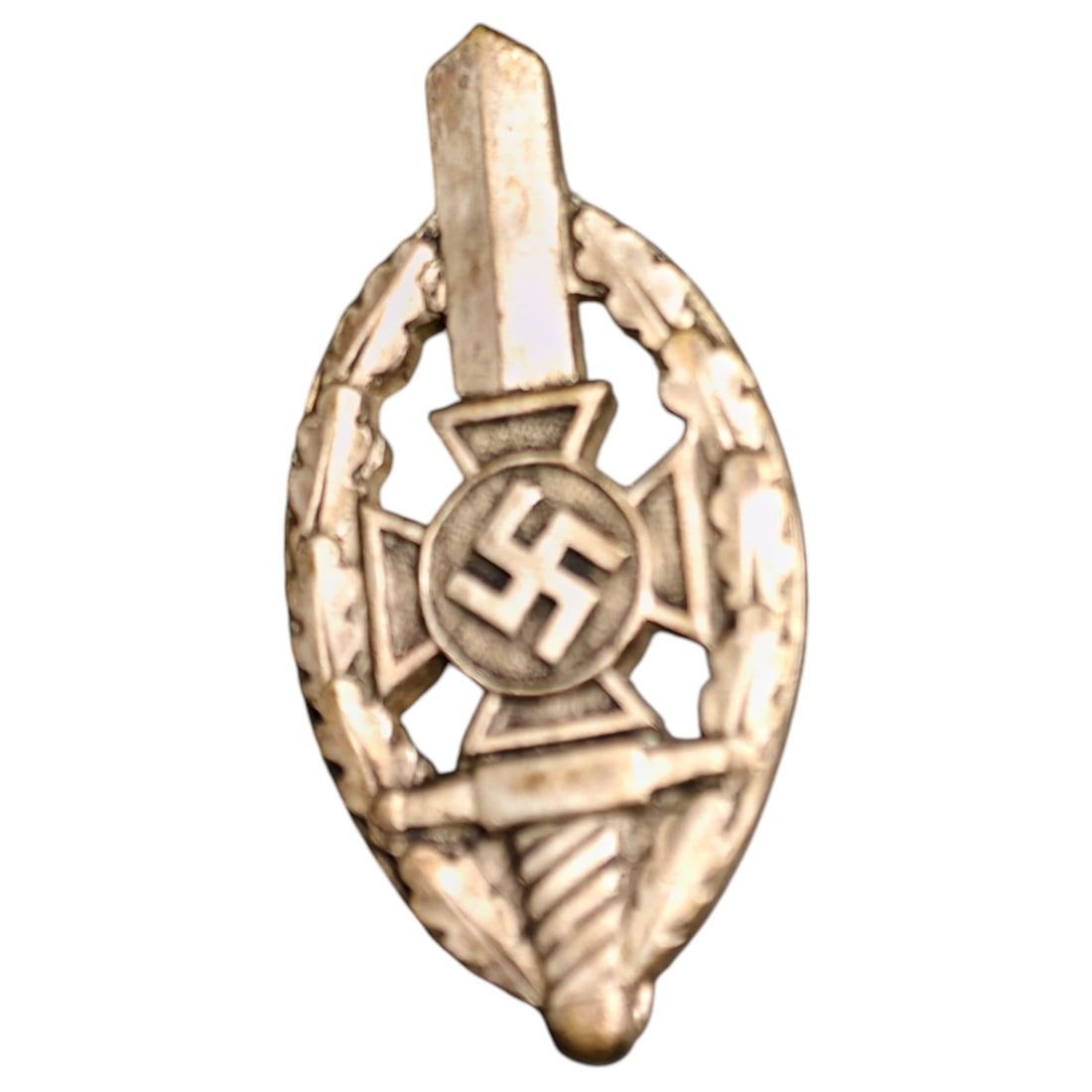 Third Reich Veterans Association Pin Badge: A miniature pin badge in the form of an oval wreath enclosing a sword, cross pattée, and mobile swastika roundel, likely worn by members of a Third Reich veterans' or ex-servicemen's association. Rev