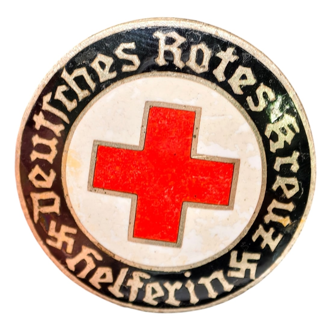 Third Reich Nazi Red Cross Badge: Enameled member badge for the Deutsches Rotes Kreuz (German Red Cross), inscribed "DEUTSCHES ROTES KREUZ HELFERIN" around a central red cross on white enamel field with black outer ring and gothic