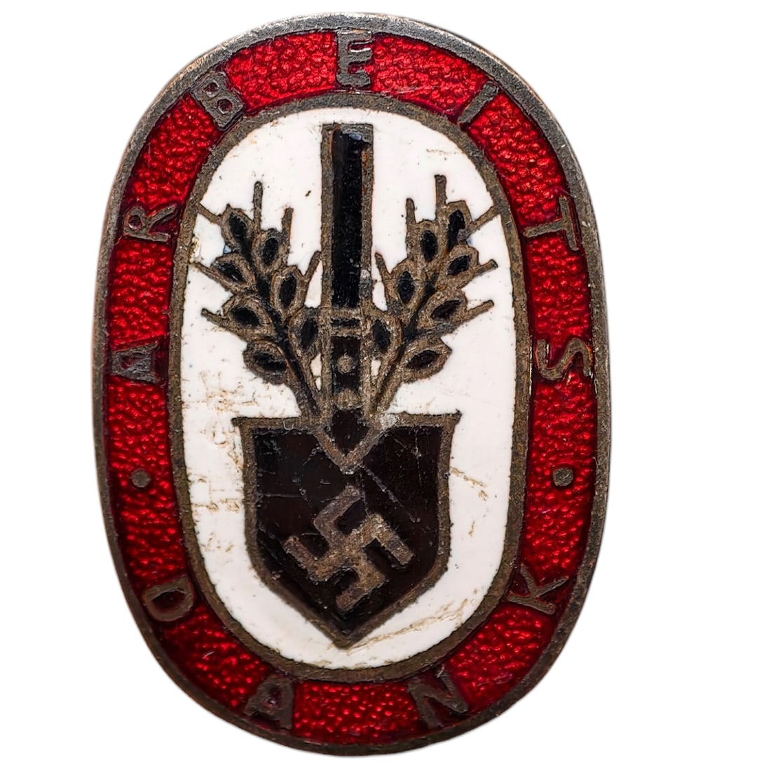 Third Reich Nazi RAD Arbeits Dank Badge: Enameled tinnie/donation badge with red oval border reading 'ARBEITS DANK' surrounding a white field with a crossed spade and wheat sheaf motif over a shield bearing a swastika.