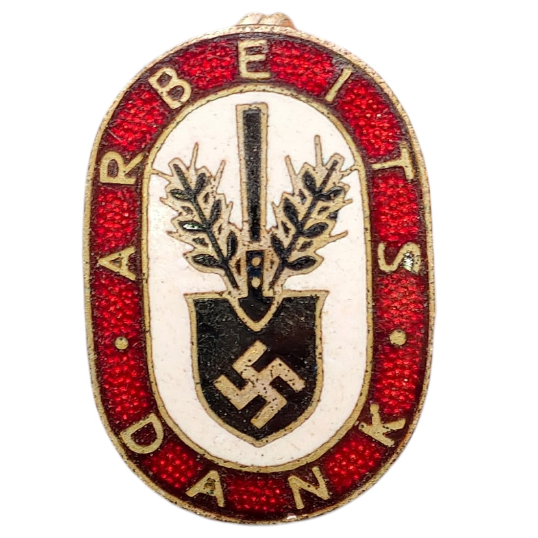 Third Reich Nazi RAD Arbeits Dank Badge: Enameled tinnie/donation badge with red oval border reading 'ARBEITS DANK' surrounding a white field with a crossed spade and wheat sheaf motif over a shield bearing a swastika.