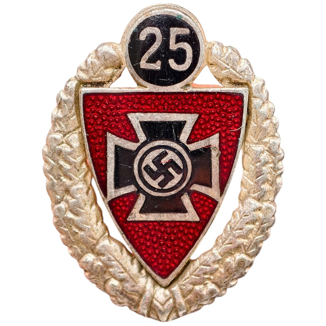 Third Reich 25 Year Veterans Association Badge: A Third Reich era Kyffhäuserbund veterans association badge marking 25 years of membership, featuring a red enameled shield with a center in what appears to be silvered Iron Cross bearing a mobile sw