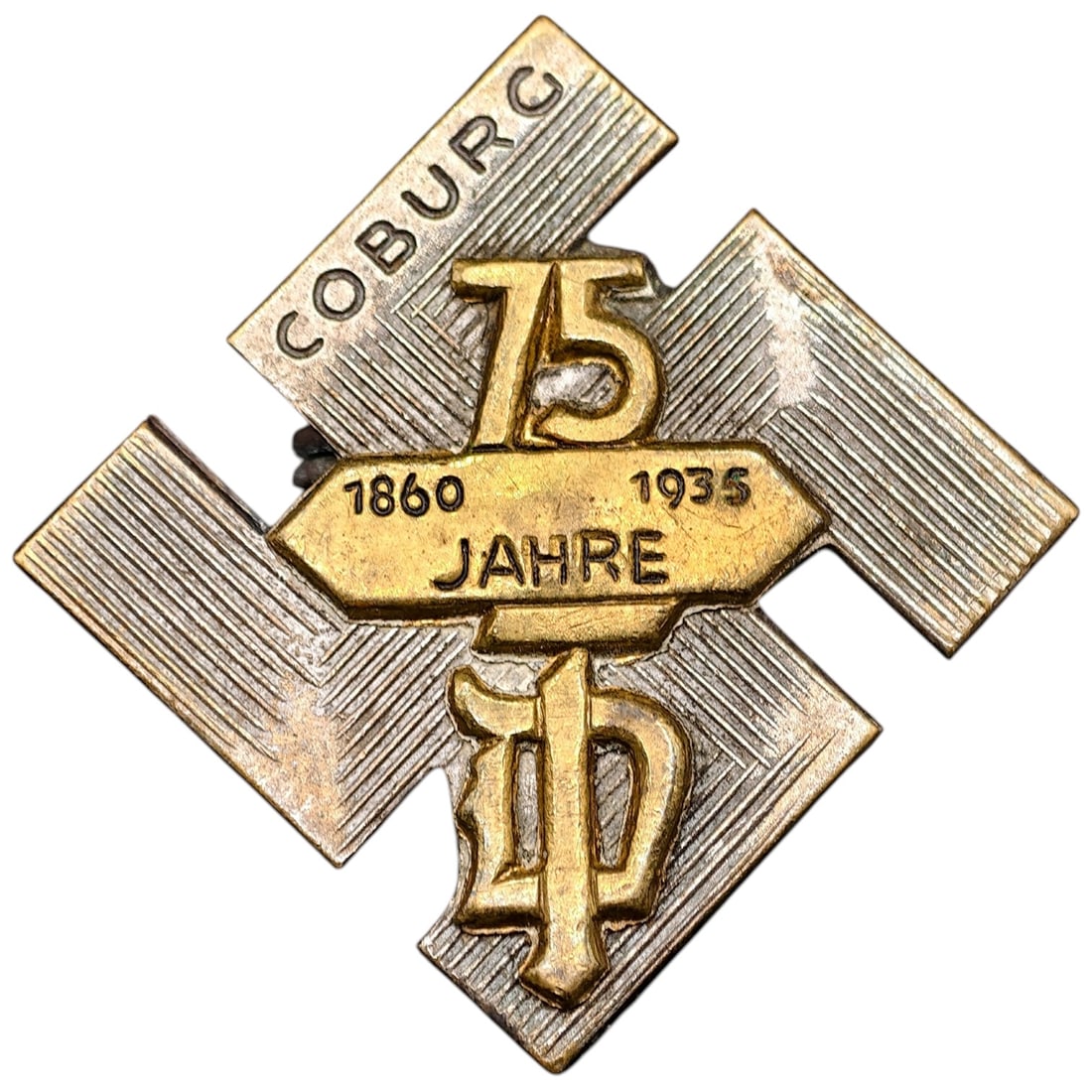 NSDAP Coburg 1860 1935 Jahre Badge: A badge commemorating 75 years (1860-1935) associated with Coburg, formed in a swastika-shaped design with a raised gilt '75' and 'JAHRE' banner, 'COBURG' arcing across the upper arm. Maker-marked on 