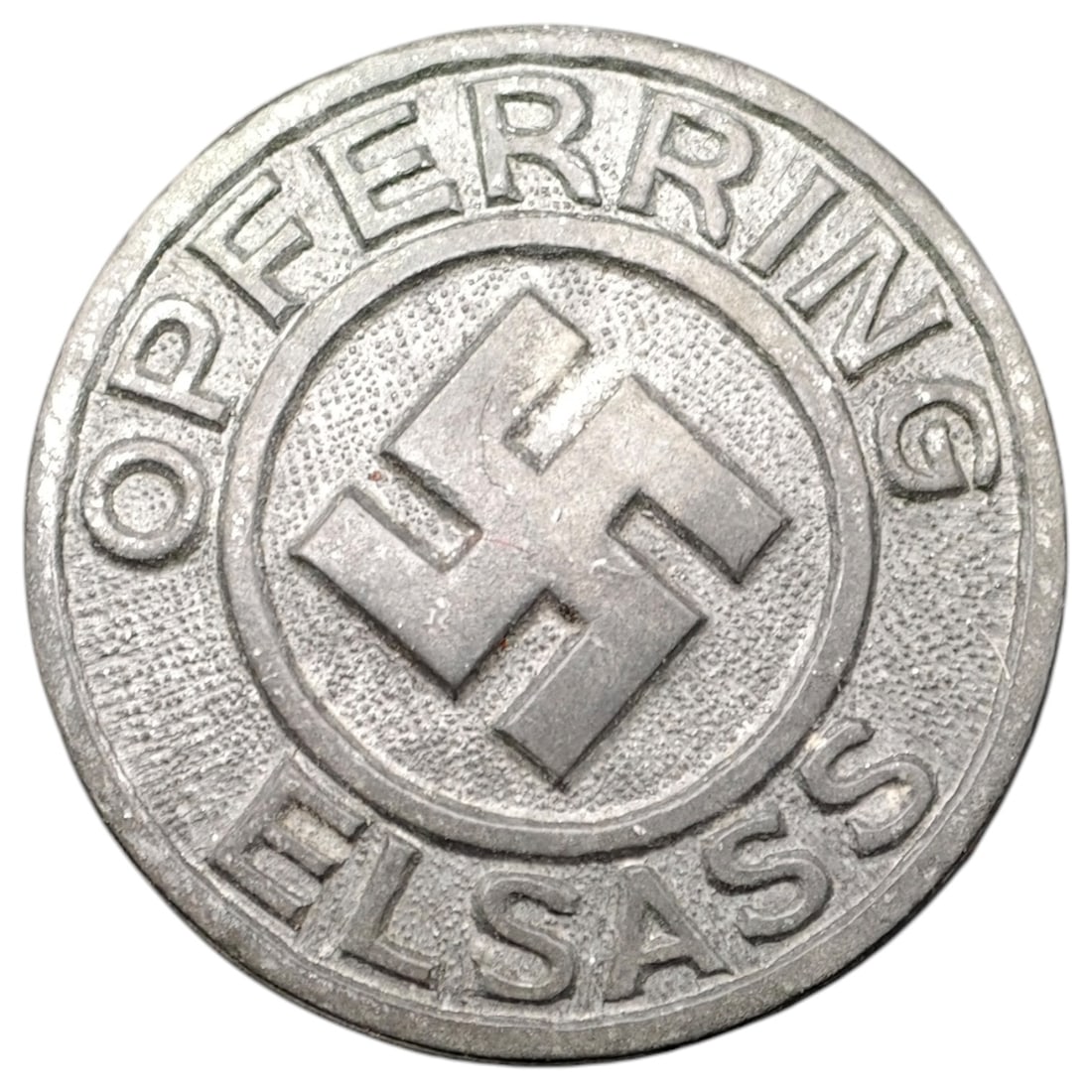 Third Reich Nazi Opfering Elsass Badge: Round aluminum donation/membership badge inscribed "OPFERRING ELSASS" encircling a central raised swastika. The reverse is maker-marked "R. HAUSCHILD – PFORZHEIM". This badge relates to the Nazi-era