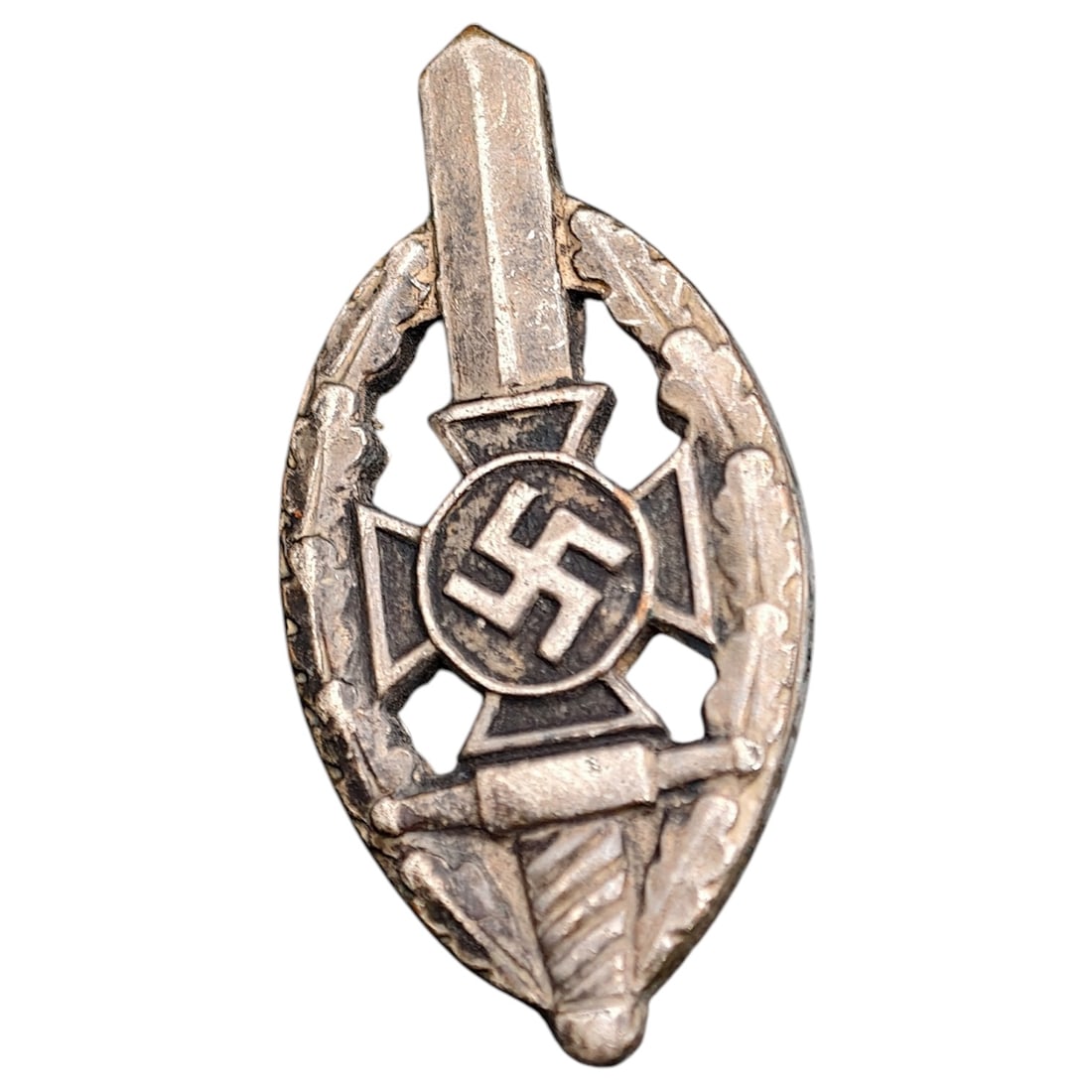 Third Reich Veterans Association Pin Badge: A miniature pin badge in the form of an oval wreath enclosing a sword, cross pattée, and mobile swastika roundel, likely worn by members of a Third Reich veterans' or ex-servicemen's association. Rev