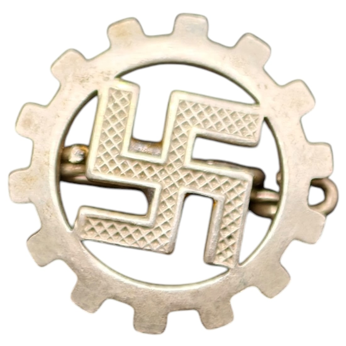 Third Reich Nazi DAF Pin Badge: A small gear-shaped membership pin badge for the Deutsche Arbeitsfront (German Labor Front), featuring a central mobile swastika within a cogwheel. Reverse shows a maker/RZM-type numeric stamp,