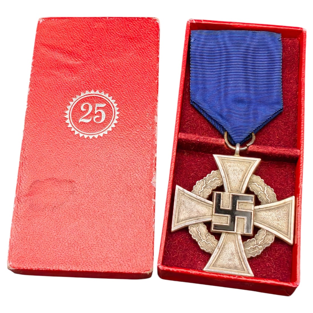 Third Reich Nazi 25 Year Faithful Service Boxed Medal: A cross-form medal in what appears to be silvered metal for 25 years of faithful service (Treudienst-Ehrenzeichen), reverse inscribed 'Für treue Dienste' within an oak leaf wreath, obverse bearing a