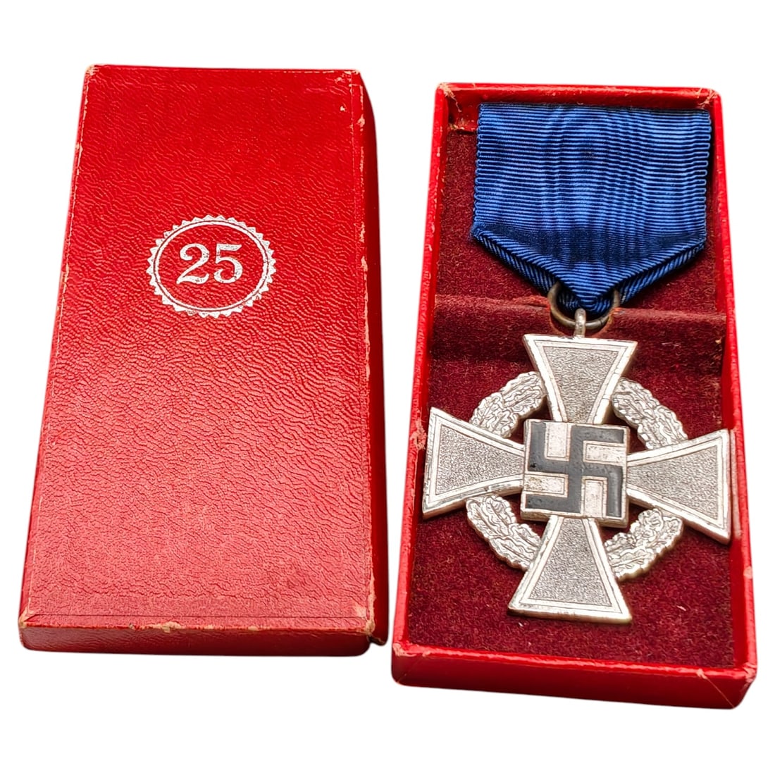 Third Reich Nazi 25 Year Faithful Service Boxed Medal: A cross-form medal in what appears to be silvered metal for 25 years of faithful service (Treudienst-Ehrenzeichen), reverse inscribed 'Für treue Dienste' within an oak leaf wreath, obverse bearing a 