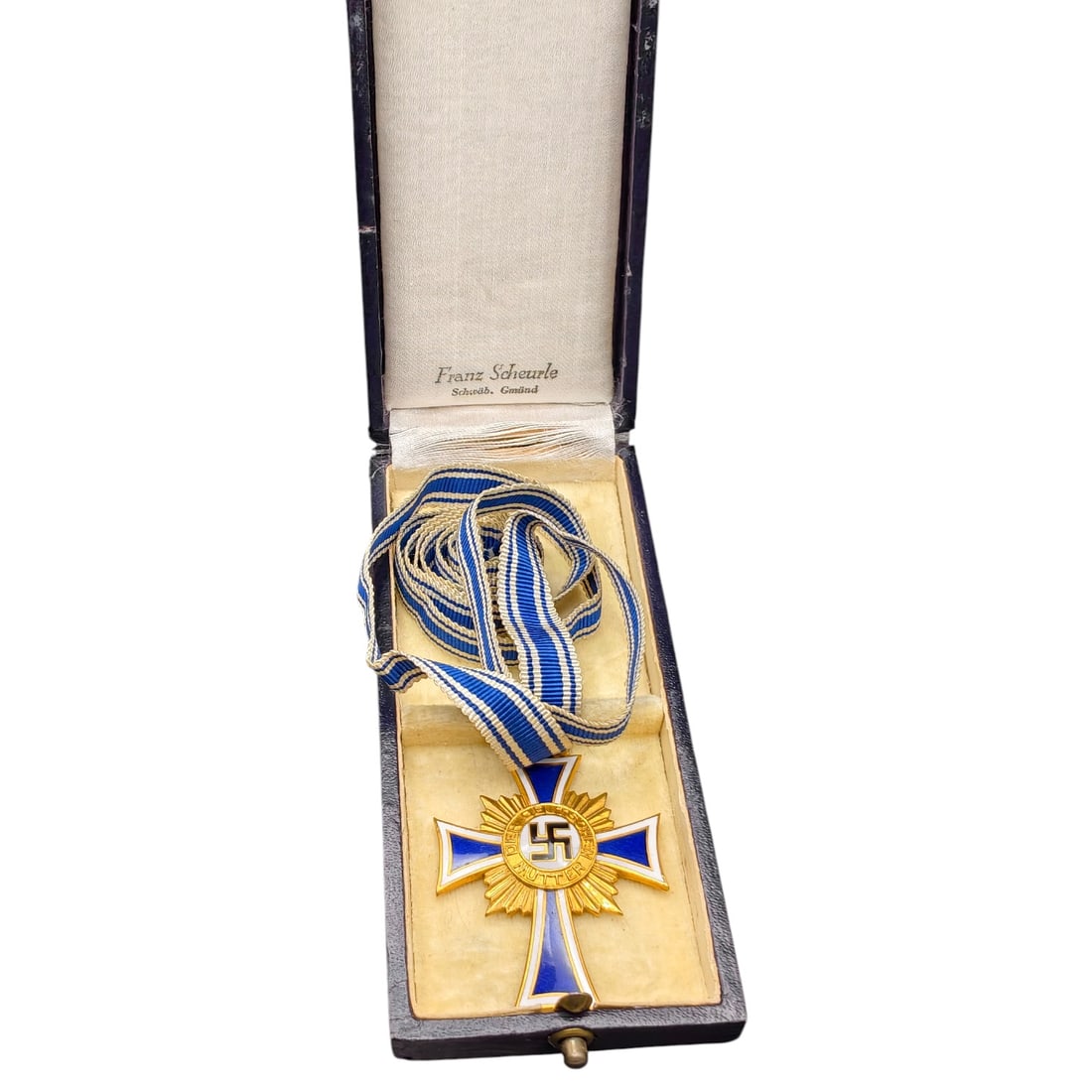 Mothers Cross in Gold – Third Reich Nazi Era Medal in Box: This is a Third Reich era Ehrenkreuz der Deutschen Mutter (Cross of Honor of the German Mother) in gold grade, awarded to mothers of large families. The obverse features a central roundel with a swast