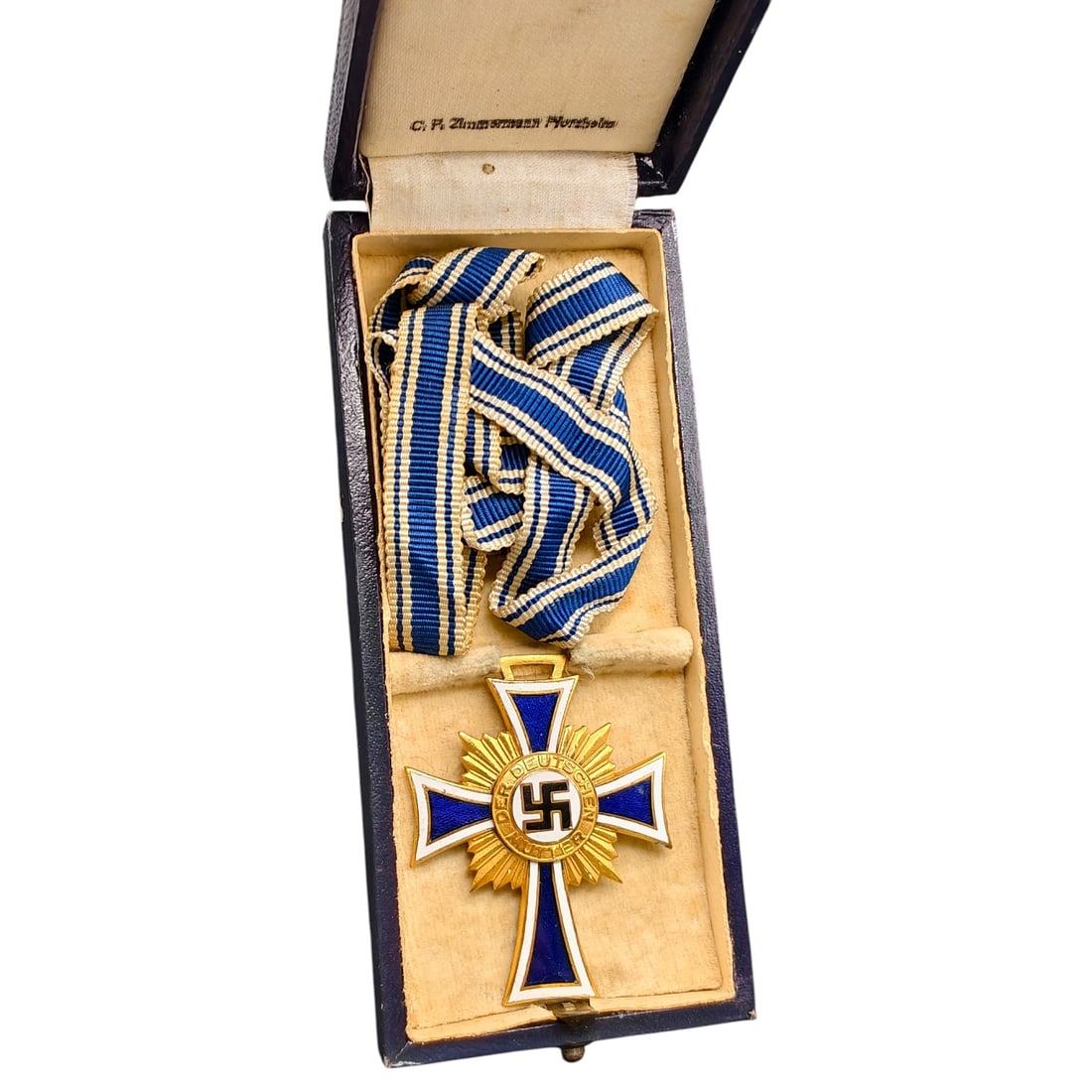 Mothers Cross in Gold – Third Reich Nazi Era Medal in Box: This is a Third Reich era Ehrenkreuz der Deutschen Mutter (Cross of Honor of the German Mother) in gold grade, awarded to mothers of large families. The obverse features a central roundel with a swast