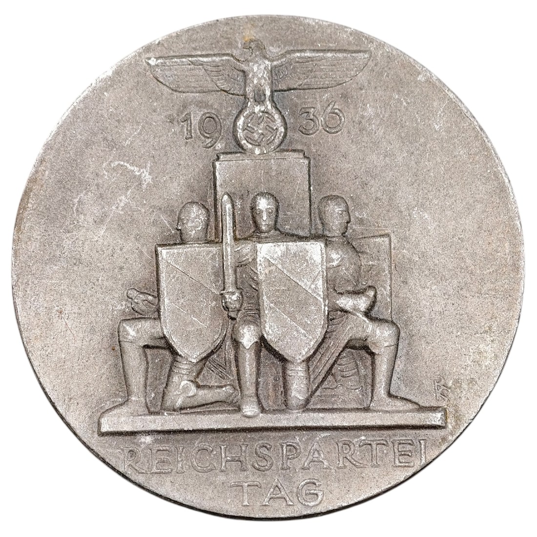 NSDAP Reichsparteitag 1936 Badge: A pin-back tinnie commemorating the 1936 Reichsparteitag, depicting a set of kneeling standard bearers with shields beneath a Party eagle and swastika, dated '1936' above and 'REICHSPARTEI TAG' below.
