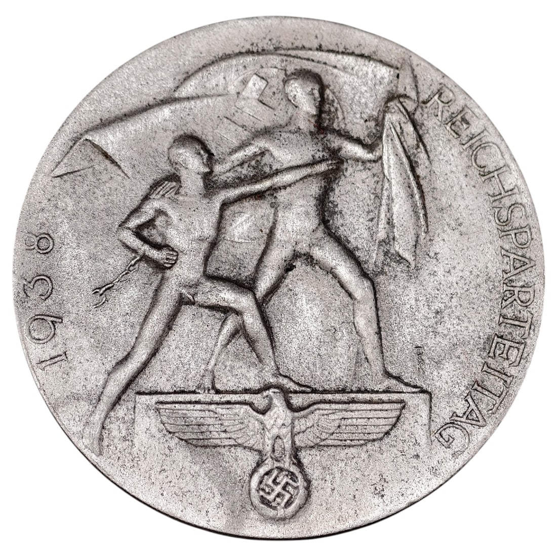 Third Reich Reichsparteitag 1938 Tinnie Badge: A pin-back tinnie commemorating the 1938 Reichsparteitag (Nazi Party Rally at Nuremberg), depicting two allegorical male figures with a banner above a Party eagle and swastika, with 'REICHSPARTEITAG' 