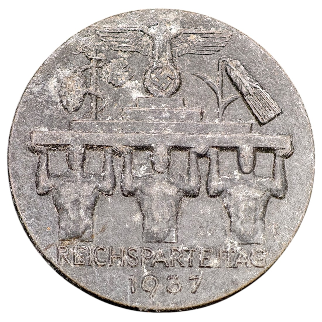 Third Reich Reichsparteitag 1937 Tinnie Badge: A commemorative tinnie badge issued for the 1937 Reichsparteitag (Nazi Party Rally at Nuremberg), depicting a set of laborers with raised arms supporting a beam beneath a national eagle emblem, flanke