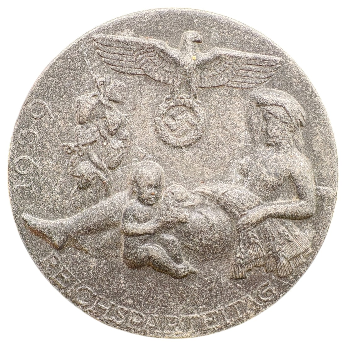 Third Reich Reichsparteitag 1939 Tinnie Badge: A commemorative pin badge (tinnie) for the 1939 Reichsparteitag (Nazi Party Rally at Nuremberg), depicting a mother with children beneath a Party eagle and wreath, dated 1939 with 'REICHSPARTEITAG' be