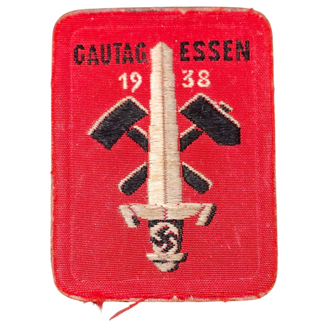 German 1938 'Gautag Essen' Cloth Rally Badge: A woven cloth membership/tinnie-style badge produced for the 1938 Gautag Essen regional Nazi party rally. The red woven fabric features 'GAUTAG ESSEN 1938' text above a crossed-hammer motif with a