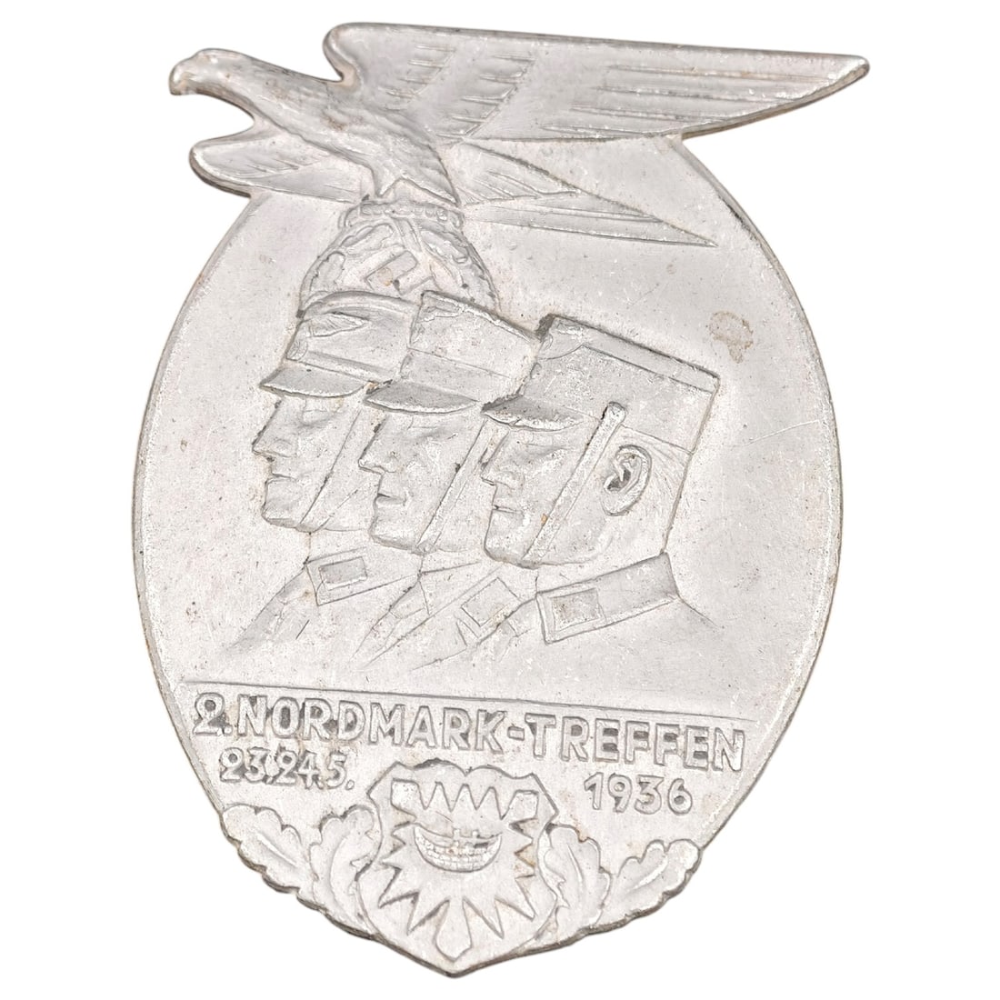 Third Reich NSDAP Kreistag 1939 Tinnie Badge: A pressed metal tinnie commemorating the 2. Nordmark-Treffen (regional rally) held 23-24.5.1936, depicting a set of uniformed men's profiles beneath a stylized eagle with outstretched wings. The rever